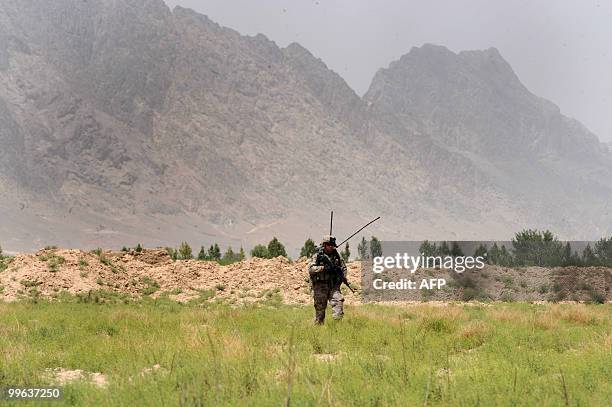 Soldier from Bravo Troop 1-71 CAV patrols in Belanday village, Dand district in Kandahar on May 17, 2010. NATO and the United States are deploying...