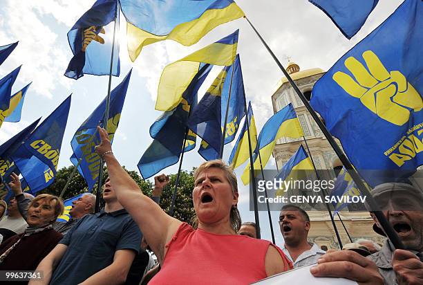 Activists of the Ukrainian nationalist party 'Svoboda' hold flags and shout slogans during a protest against the visit of Russian President Dmitry...