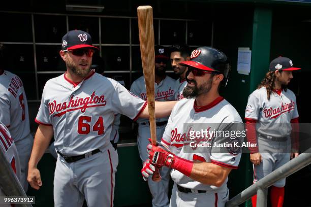 Spencer Kieboom of the Washington Nationals talks to Adam Eaton before the game against the Pittsburgh Pirates at PNC Park on July 11, 2018 in...