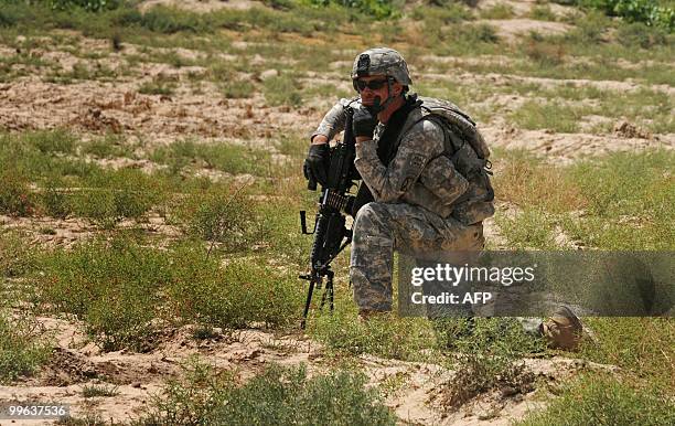 Soldier from Bravo Troop 1-71 CAV looks on during a patrol in Belanday village, Dand district in Kandahar on May 17, 2010. NATO and the United States...