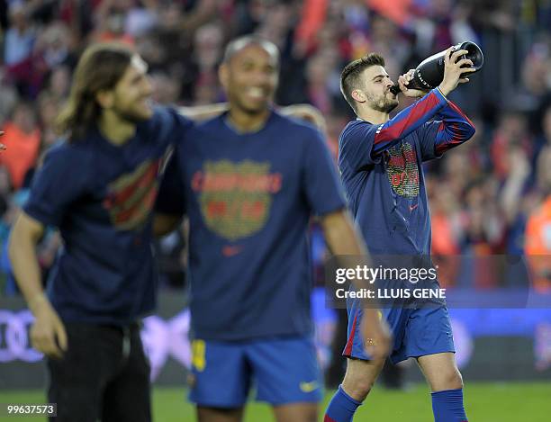 Barcelona's defender Gerard Pique celebrates with teammates after winning their Spanish League football match against Valladolid at Camp Nou stadium...