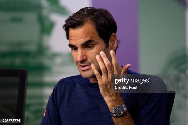 Roger Federer of Switzerland talks to the media at a press conference after losing his Men's Singles Quarter-Finals match against Kevin Anderson of...