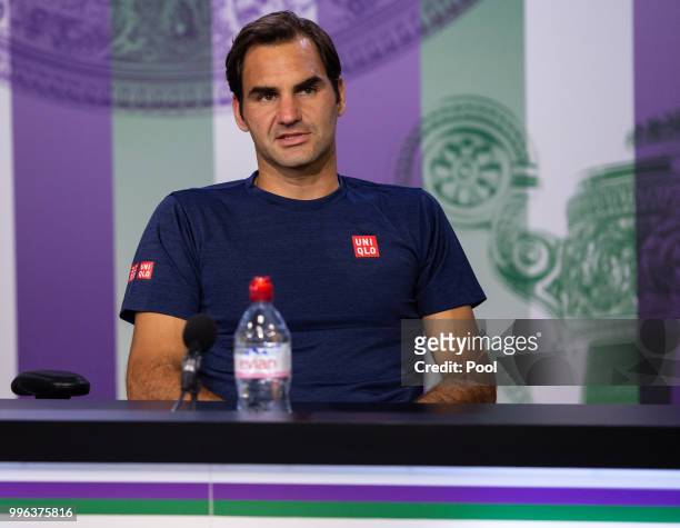 Roger Federer of Switzerland talks to the media at a press conference after losing his Men's Singles Quarter-Finals match against Kevin Anderson of...