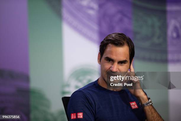 Roger Federer of Switzerland talks to the media at a press conference after losing his Men's Singles Quarter-Finals match against Kevin Anderson of...