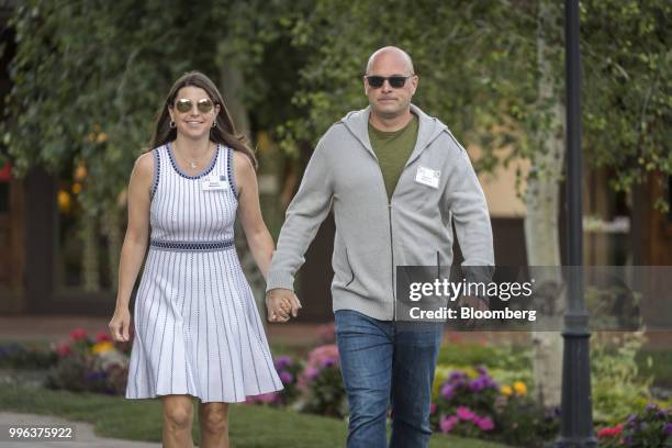Roberto Mignone, founder of Bridger Management LLC, and Allison Mignone arrive for a morning session of the Allen & Co. Media and Technology...