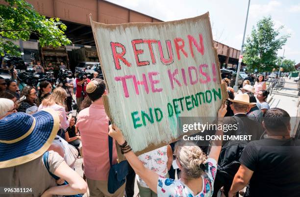 Protesters hold signs as Ravi Ragbir, of the New Sanctuary Coalition, speaks at a press conference to spotlight the impact of the governments...