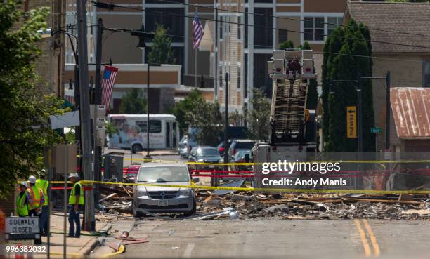 Investigators survey a scene on Main Street after a gas leak explosion destroyed at least four buildings on July 11, 2018 in Sun Prairie, Wisconsin....