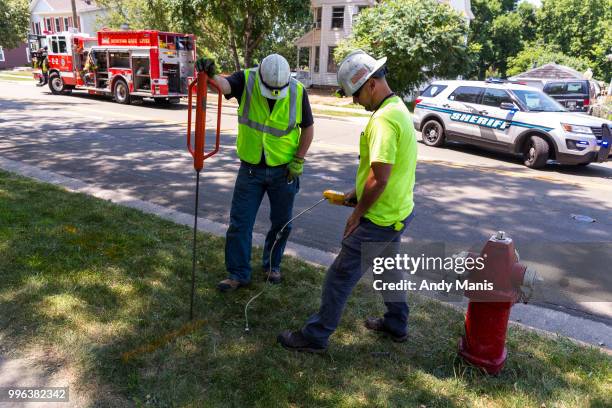 We Energies employees check for gas leaks in the ground after a gas leak explosion destroyed at least four buildings on July 11, 2018 in Sun Prairie,...