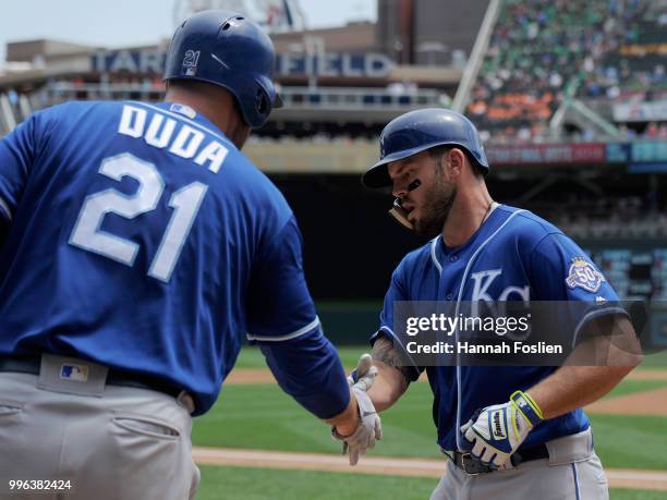 Lucas Duda of the Kansas City Royals congratulates teammate Mike Moustakas on a solo home run against the Minnesota Twins during the third inning of...