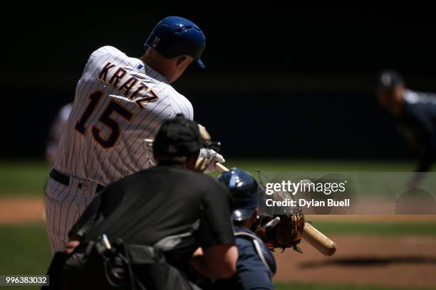 Erik Kratz of the Milwaukee Brewers swings at a pitch in the second inning against the Atlanta Braves at Miller Park on July 8, 2018 in Milwaukee,...