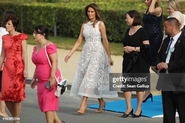 First Lady Melania Trump and other spouses of heads of state and governments attend the evening reception and dinner at the 2018 NATO Summit on July...