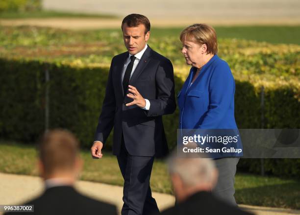 French President Emmanuel Macron and German Chancellor Angela Merkel arrive for a group photo of heads of states and governments during the evening...