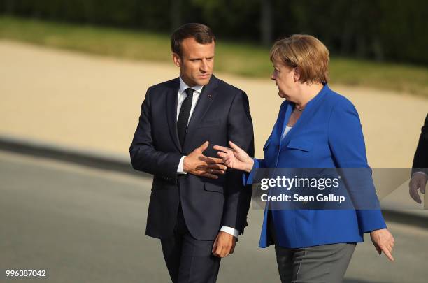 French President Emmanuel Macron and German Chancellor Angela Merkel arrive for a group photo of heads of states and governments during the evening...