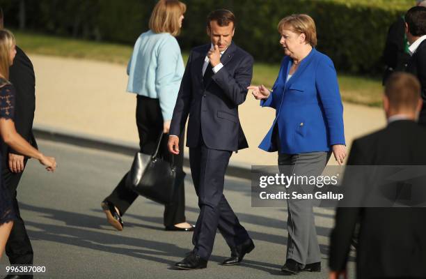 French President Emmanuel Macron and German Chancellor Angela Merkel arrive for a group photo of heads of states and governments during the evening...