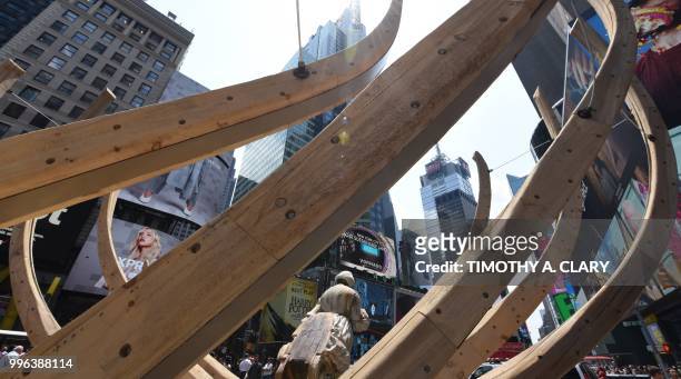 The work of artist Mel Chin, "Wake" and "Unmoored, is unveiled on Times Square July 11, 2018 in New York, part of the mixed reality piece developed...