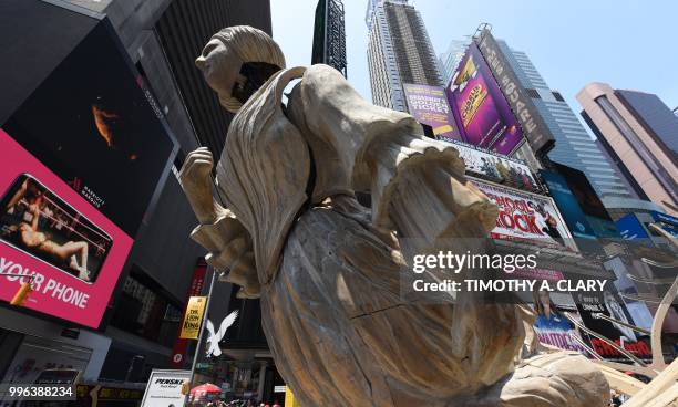 The work of artist Mel Chin, "Wake" and "Unmoored, is unveiled on Times Square July 11, 2018 in New York, part of the mixed reality piece developed...