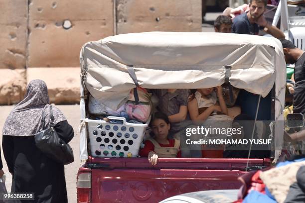 Displaced Syrians from the Daraa province come back to their hometown in Bosra, southwestern Syria, on July 11, 2018. Syria's southern province of...