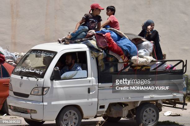 Displaced Syrians from the Daraa province come back to their hometown in Bosra, southwestern Syria, on July 11, 2018. - Syria's southern province of...