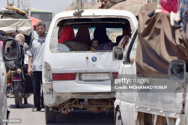 Displaced Syrians from the Daraa province come back to their hometown in Bosra, southwestern Syria, on July 11, 2018. - Syria's southern province of...