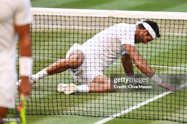 Juan Martin Del Potro of Argentina lays on the court against Rafael Nadal of Spain during their Men's Singles Quarter-Finals match on day nine of the...