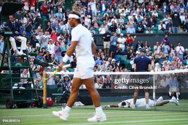 Juan Martin Del Potro of Argentina lays on the court against Rafael Nadal of Spain during their Men's Singles Quarter-Finals match on day nine of the...