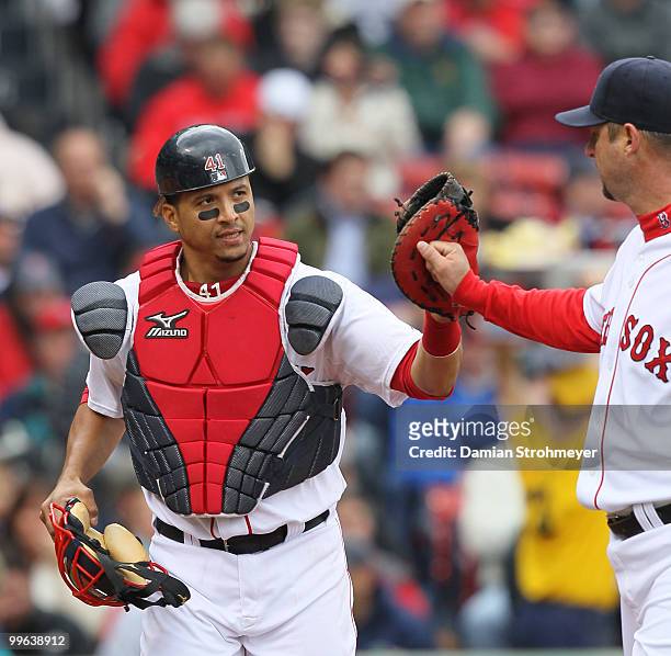 Victor Martinez of the Boston Red Sox high fives Red Sox pitcher Tim Wakefield during the game between the Toronto Blue Jays and the Boston Red Sox...