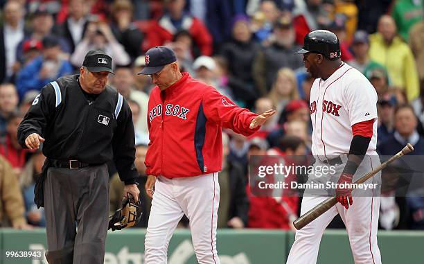 Manager Terry Francona of the Boston Red Sox restrains David Ortiz and argues a third strike call with Home Plate umpire Dale Scott during the game...