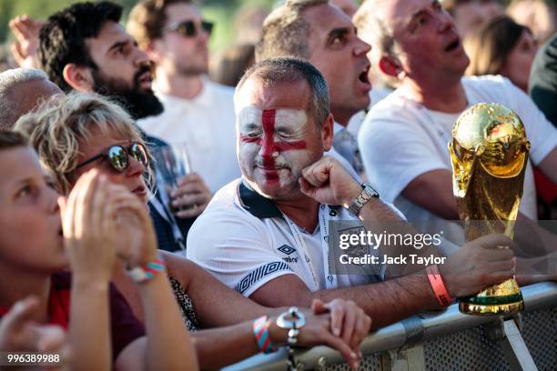 England football fans react as they watch the Hyde Park screening of the FIFA 2018 World Cup semi-final match between Croatia and England on July 11,...