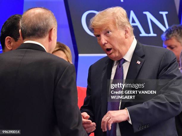 President Donald Trump talks to Turkish President Recep Tayyip Erdogan as they arrive for a dinner of leaders at the Art and History Museum at the...