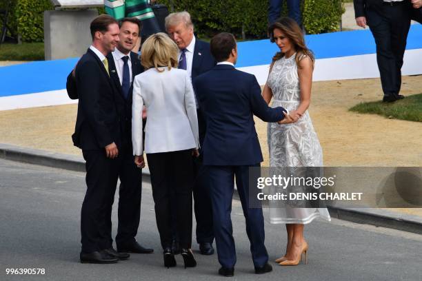 President Donald Trump speaks with Luxembourg's Prime Minister Xavier Bettel , French President's wife Brigitte Macron , husband of Luxembourg's...