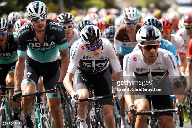 Daniel Oss of Italy and Team Bora Hansgrohe / Christopher Froome of Great Britain and Team Sky rides in the peloton during stage five of the 105th...