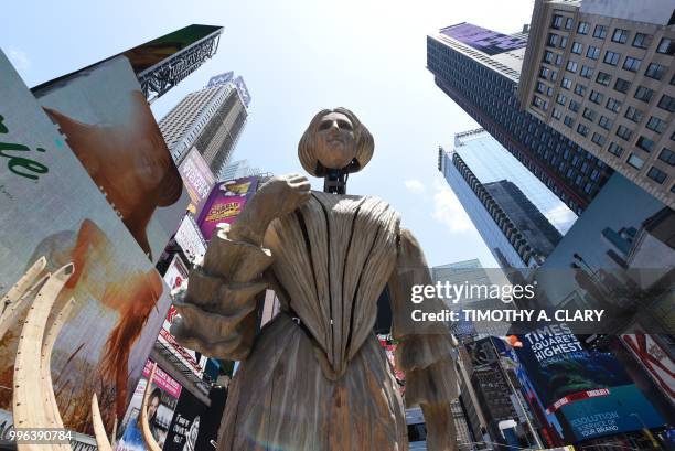 The work of artist Mel Chin, "Wake" and "Unmoored, is unveiled on Times Square July 11, 2018 in New York, part of the mixed reality piece developed...