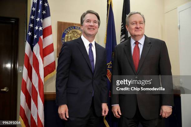 Judge Brett Kavanaugh and Sen. Michael Crapo pose for photographs before a meeting in Crapo's offices in the Dirksen Senate Office Building on...