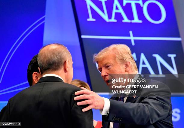 President Donald Trump speaks with Turkish President Recep Tayyip Erdogan as they arrive for a working dinner at the Art and History Museum in The...