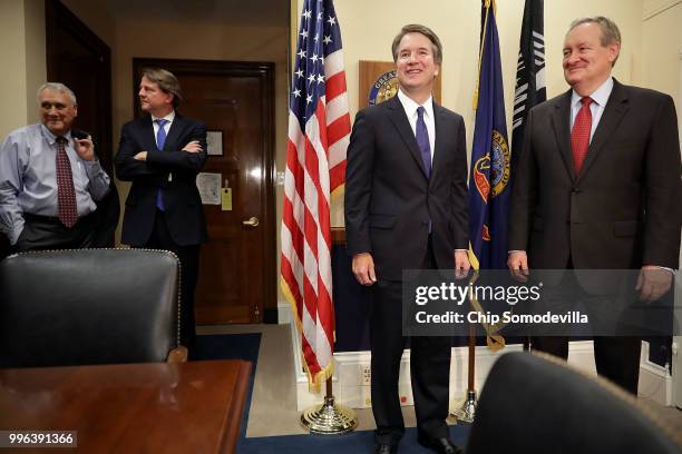 Judge Brett Kavanaugh and Sen. Michael Crapo pose for photographs as former Sen. Jon Kyl and White House Counsel Don McGahn stand by before a meeting...