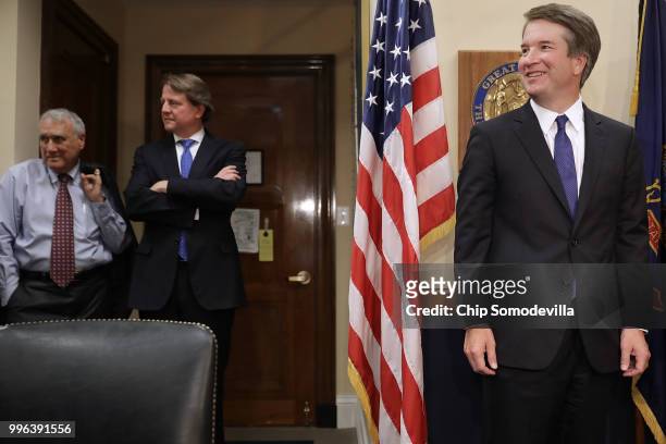 Judge Brett Kavanaugh poses for photographs as former Sen. Jon Kyl and White House Counsel Don McGahn stand by before a meeting with Sen. Michael...
