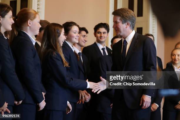 Judge Brett Kavanaugh shakes hands with members of the Senate Page program after posing for photographs with them at the U.S. Capitol July 11, 2018...