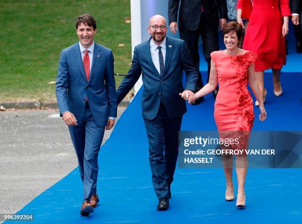 Canada's Prime Minister Justin Trudeau , Belgium's Prime Minister Charles Michel and Belgian Prime Minister's partner Amelie Derbaudrenghien smile as...