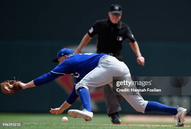 Lucas Duda of the Kansas City Royals is unable to field a throw from teammate Glenn Sparkman during the fourth inning of the game against the...