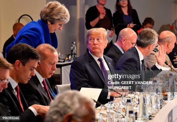 President Donald Trump looks at British Prime Minister Theresa May during a dinner of leaders at the Art and History Museum at the Park...