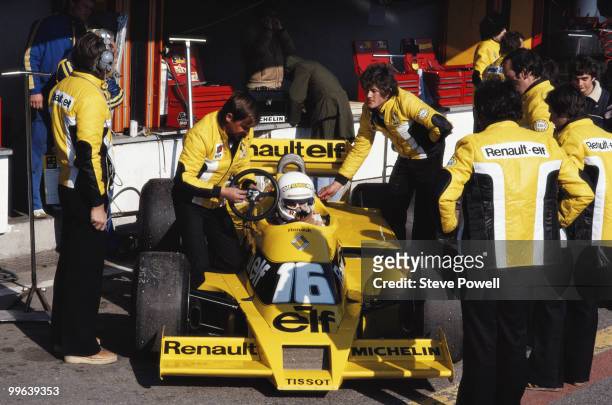 Rene Arnoux sits aboard the Equipe Renault ElfRenault RS01 Turbo as mechanics check over the car during practice for the Spanish Grand Prix on 28...