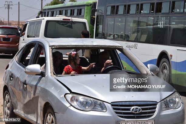 Displaced Syrians from the Daraa province come back to their hometown in Bosra, southwestern Syria, on July 11, 2018. - Syria's southern province of...