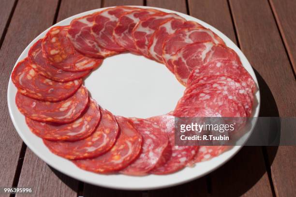 salchichon casero, "nchorizo extra, and cabecero de lomo sausage on white plate and wooden table - animal abdomen stock pictures, royalty-free photos & images