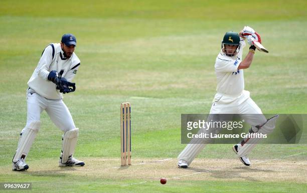 Steven Mullaney of Nottinghamshire hits out to the boundary in front of Nic Pothas of Hampshire during the LV County Championship match between...