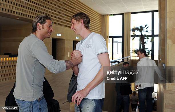 Players of the German national football team goalkeeper Tim Wiese greets striker Stefan Kiessling on May 17, 2010 as he arrives in Sciacca, Sicily,...
