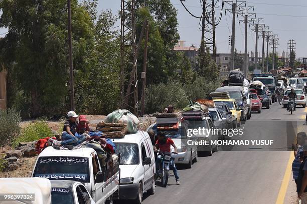 Displaced Syrians from the Daraa province come back to their hometown in Bosra, southwestern Syria, on July 11, 2018. - Syria's southern province of...