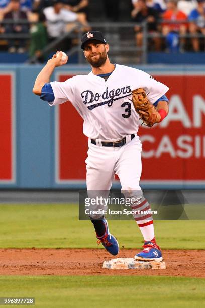 Los Angeles Dodgers infielder Chris Taylor turns a double play during a MLB game between the Pittsburgh Pirates and the Los Angeles Dodgers on July...