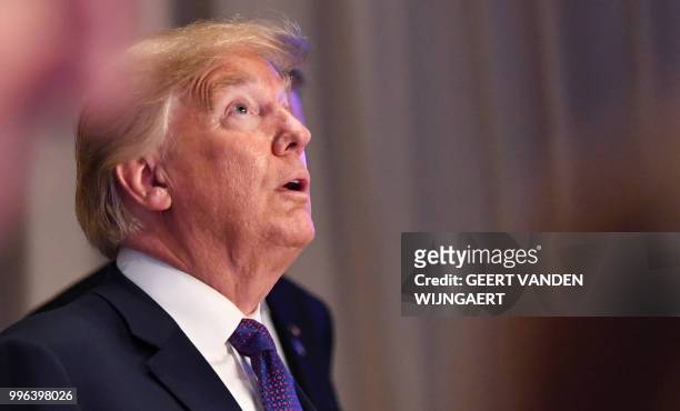 President Donald Trump looks up as he arrives for a dinner of leaders at the Art and History Museum at the Park Cinquantenaire in Brussels on July...