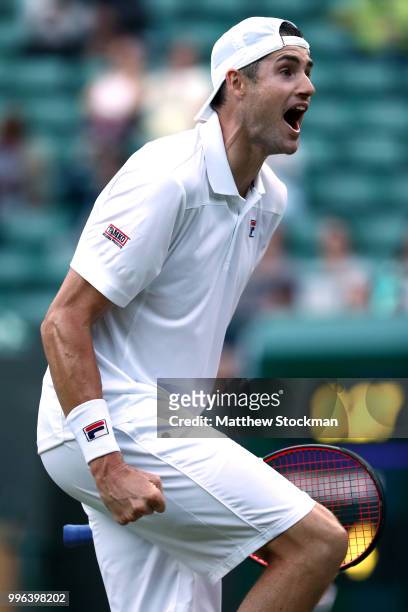 John Isner of the United States celebrates winning match point against Milos Raonic of Canada during their Men's Singles Quarter-Finals match on day...