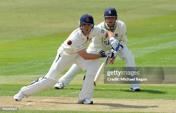 Jonathan Trott of Warwickshire looks on as Stephen Moore of Lancashire plays a shot during the LV County Championship match between Warwickshire and...